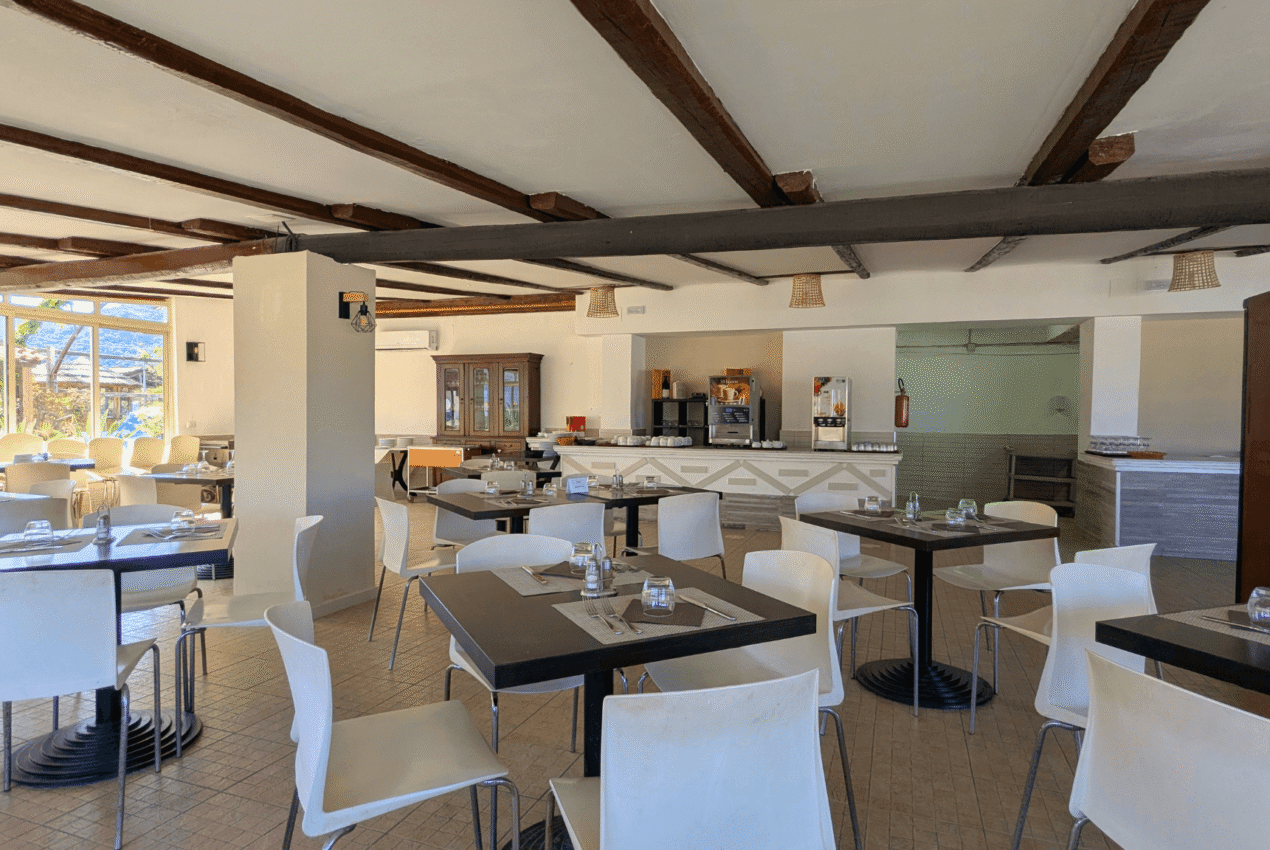 Interno del ristorante villaggio Patti Beach Resort con area buffet e distributori bevande, ideale per soggiorni in pensione completa in Sicilia